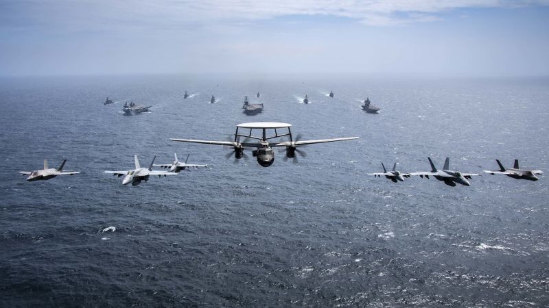 US, UK, Japanese, and Australian maritime forces transit in formation through the Bay of Bengal