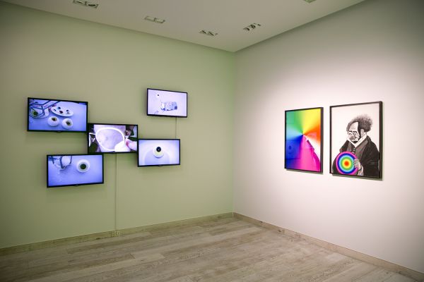 (L) Lou Hubbard, Eye Ops (2013), 5 x single channel videos. Courtesy of the artist and Sarah Scout Presents, Melbourne (R) Veronica Kent, 'Clown Transfer 1' and 'Clown Transfer 2', digital prints framed.  Courtesy of the artist and Sarah Scout Presents, Melbourne